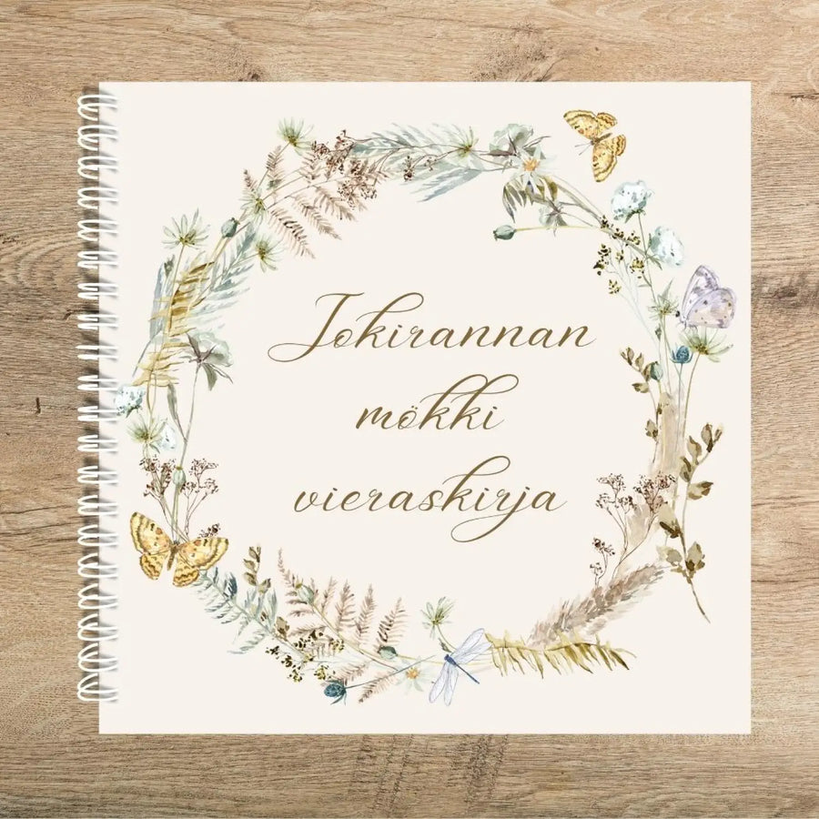 Mökin vieraskirja omalla tekstillä kukkaseppele Decopaja