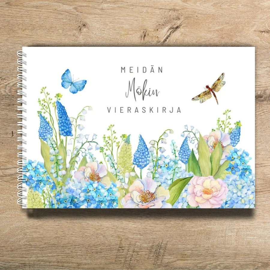 Mökki vieraskirja omalla tekstillä kukkapellon kuvalla Decopaja